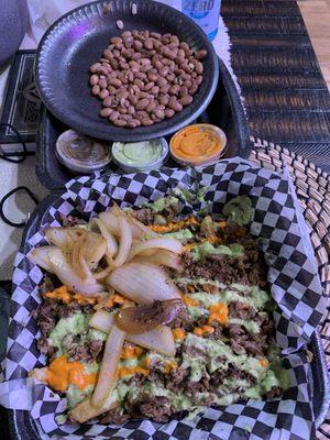 Carne asada fries with beans on the side