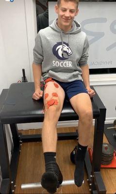 Student athlete using PowerDot to increase muscle recruitment to decrease knee pain.