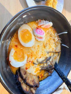 build your own ramen: spicy broth, straight ramen noodles, eggs, chasu, rice cake, bean sprouts