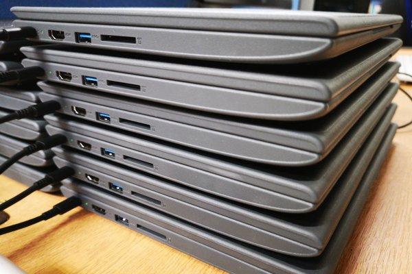 Stack of Chromebooks in for corporate/b2b repair