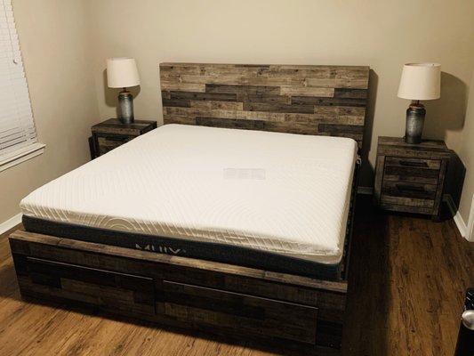 Bed frame, mattress, nightstands.