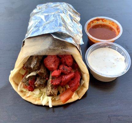 Combo of chicken, lamb, or falafel served with lettuce, tomato, and cucumber wrapped in warm pita bread with your choice of sauces on top.