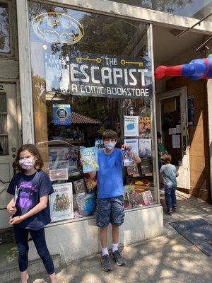 Kids in front of the sign