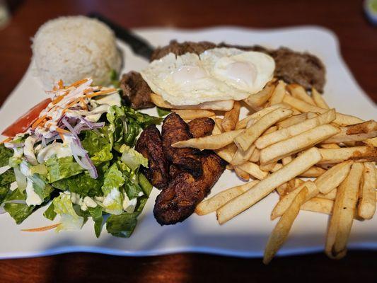 BISTEC A LO POBRE (steak topped with fried eggs and plantains, served with white rice and salad)