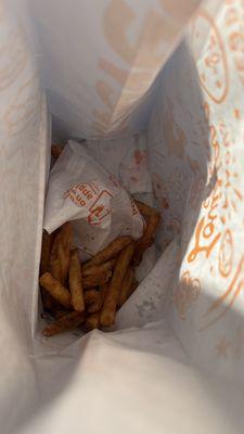 Regular Cajun Fries thrown into bag