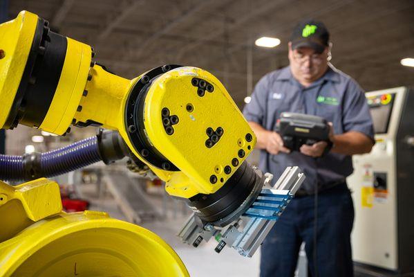 Automation Technician Working on Robot