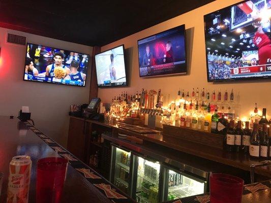 Bar area with 4 TVs and seats around 10 people.