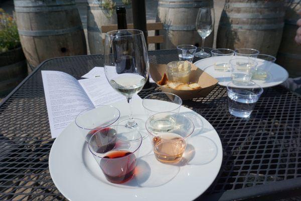 Wine tasting in times of covid (or is it always plastic??). Plastic containers for the samples to pour yourself into the one wine glass.