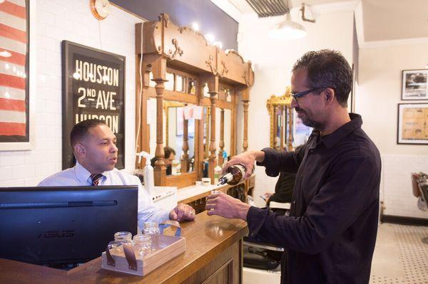 Master barber Nelson having a well deserved shot of whiskey after work