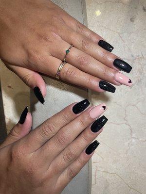 black nails with middle nude nail + black heart design