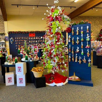 The Grinch Christmas ornaments with Department 56 village houses and grinch-themed holiday decor.