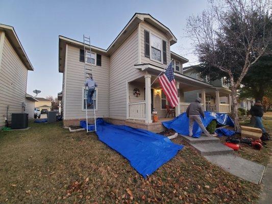 Debris control with strategically placed tarps at this American pride house!