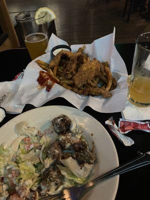 Half eaten wedge salad and we dropped in their steak bites with melted blue cheese and the other is chicken strips with fries.