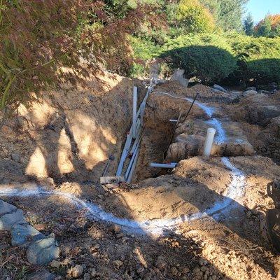 Trenches and pipes roughed in. Next will be the excavating of the pond shelfs