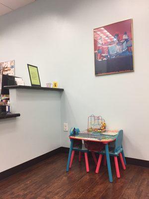 Front desk and little area for kids to play.