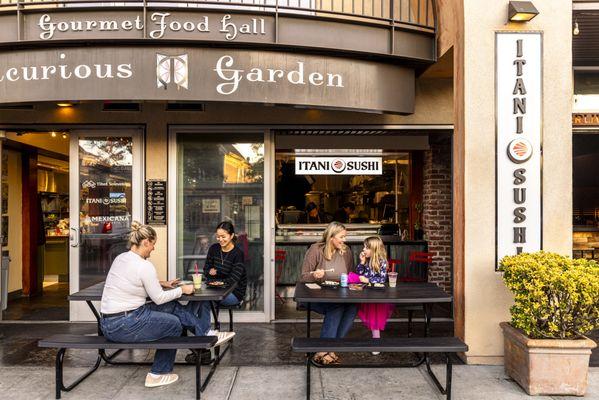 Exterior of Itani Sushi, within the Berkeley food hall, Epicurious Garden. Seating out front along Shattuck Ave, and in the back garden.