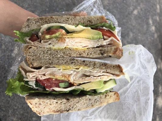 Turkey with veggies, avocado, and cheddar on black olive sourdough