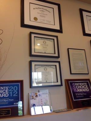 Wall of credentials in waiting area.