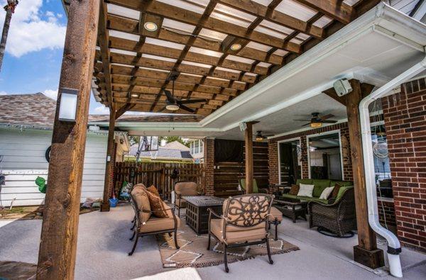 Attached cedar patio with stain, electrical and bronze polycarbonate system.