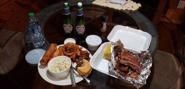 Side of slaw with a small portion of the Family Platter appetizer. On the right is the Jake's Super BBQ Sampler. Peroni goes great with this