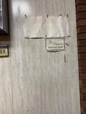 Faded signs by front door. Top one has probably been there since smoking was banned inside