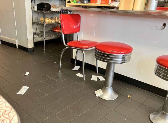 Some of the trash and food scraps observed on the floor. The staff just kept walking through it.