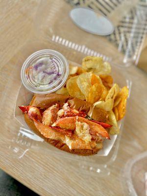 Lobster roll with coleslaw and chips