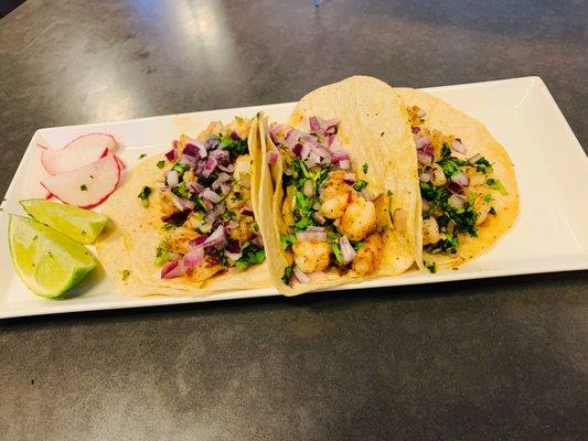 Shrimp tacos with cilantro and onion.