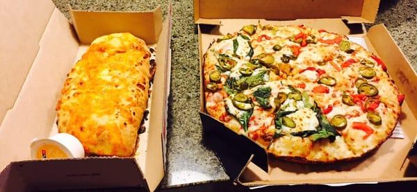 Customized pizza, full jalapeños, half spinach and half roasted red peppers. And their amazing cheesy garlic bread!