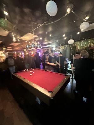 Friends around the pool table