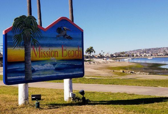 Mission Beach neighborhood sign with the bay in the background