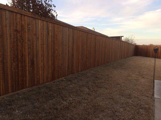 Standard 6' pre-stained white wood side by side with 2x6 baseboard and trim board on top.