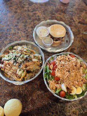 Loaded baked potato with shredded chicken, pulled pork Cobb salad, brisket sandwich