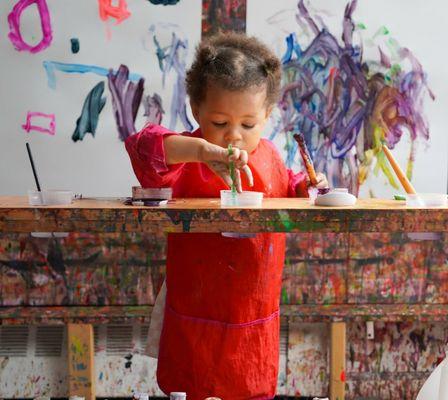 A toddler painting at our large scale painting area!