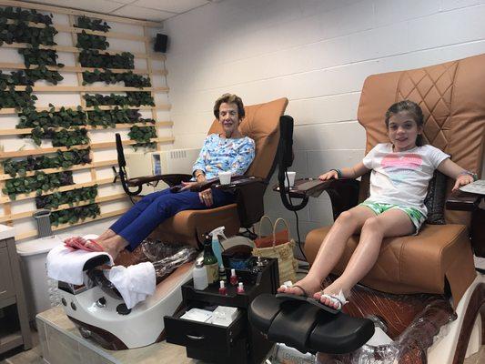 This sweet little girl had her first pedicure and manicure .