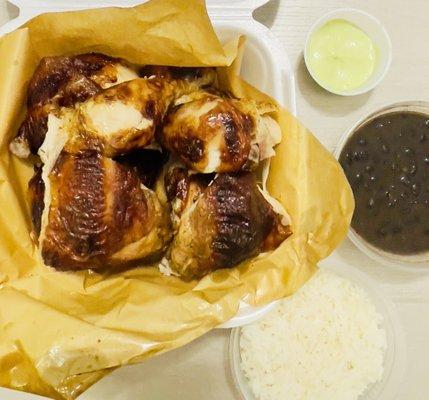 Rotisserie chicken with green sauce, rice and beans