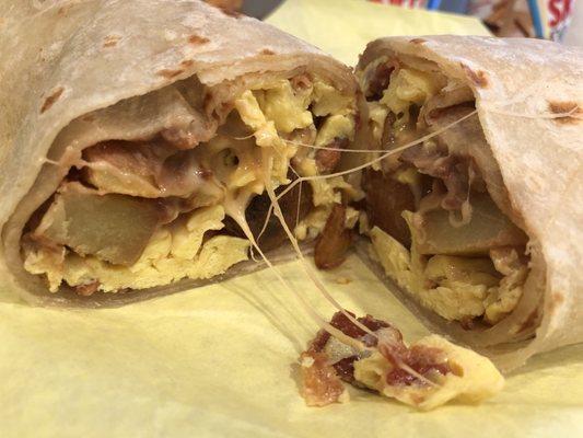 Super breakfast burrito with bacon and potatoes.