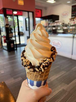 Vanilla soft serve in waffle cone