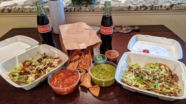 Chips with salsa/guacamole and steak and al pastor tostadas with two Mexican cokes