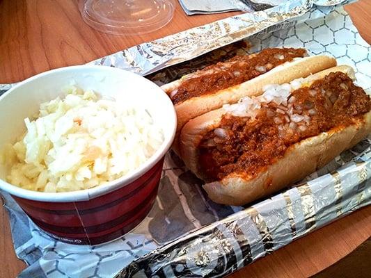 Two chili cheese dogs with side of slaw.