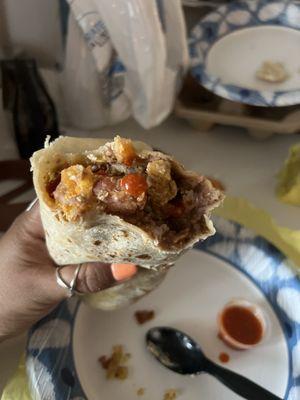 Bacon Burrito Breakfast with added beans.  Has Eggs, Cheese, Bacon, beans and potato.