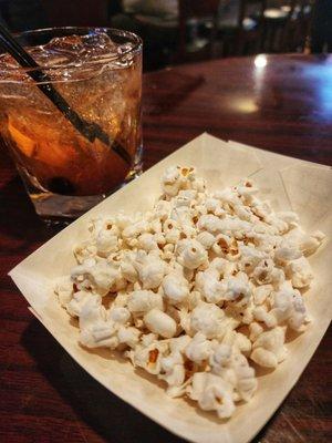 Complimentary popcorn + bourbon old fashioned