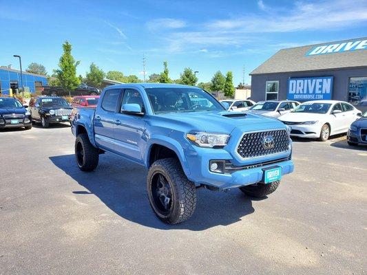 Lifted blue Toyota Tacoma at Driven used car dealership in Boise, ID