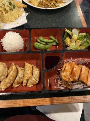 Bento box with teriyaki salmon and gyoza