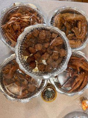 Mala duck necks on top. clockwise from top right: duck wings, chicken feet, pigs feet, tripe.