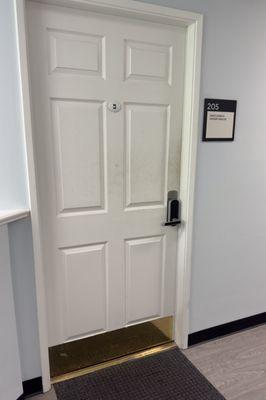 Behind this door, inside an office building.