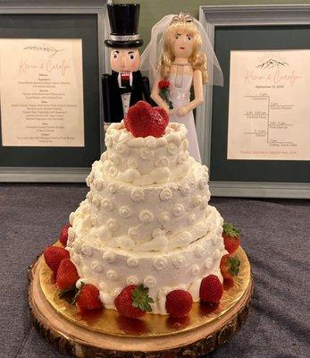 3 tiered vanilla wedding cake with whipped cream frosting and strawberries