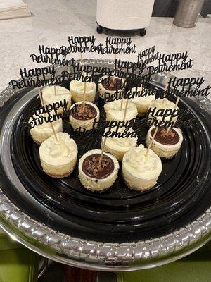 Key lime, chocolate peanut butter cup and classic mini cheesecakes. The "Happy Retirement" toppers are not included.