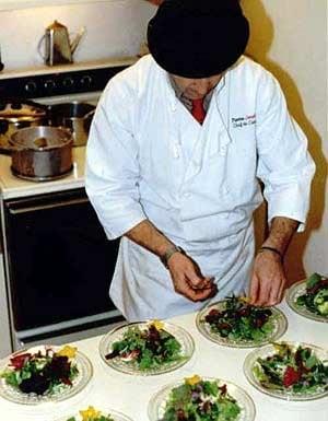 Chef PIerre garnishing a salad for party in Back Bay