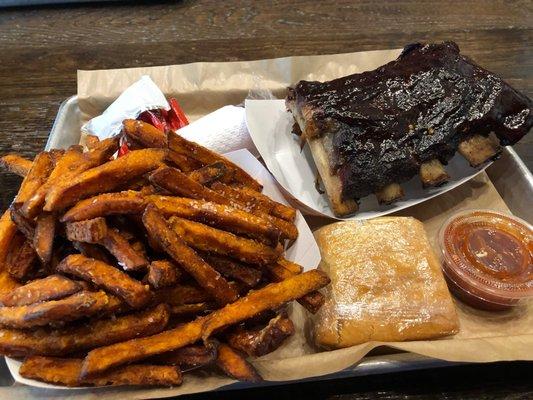 Ribs, sweet potato fries and cornbread, sauce.